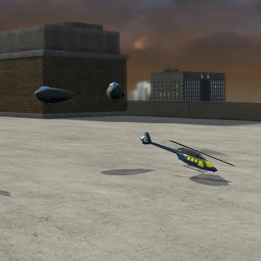 Two toy blimps and one toy helicopter on a rooftop